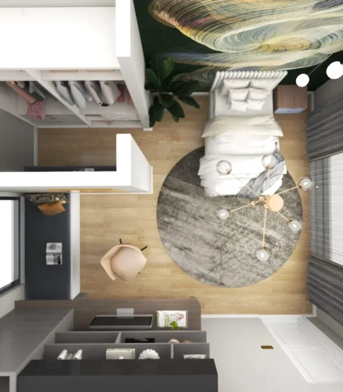 Yatak, yuvarlak halı ve avize bulunan modern bir yatak odasının havadan görünümü. Şık dolaplar kıyafetleri sergiliyor. Pencerenin yanında, iç mimar tasarım ofisinden alınan Basic bir çalışma masası alanı tamamlarken, büyük soyut sanat eserleri bu villadan esinlenen inziva yerini yüceltiyor.